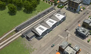 Rail station game view with platform tracks and street-facing buildings