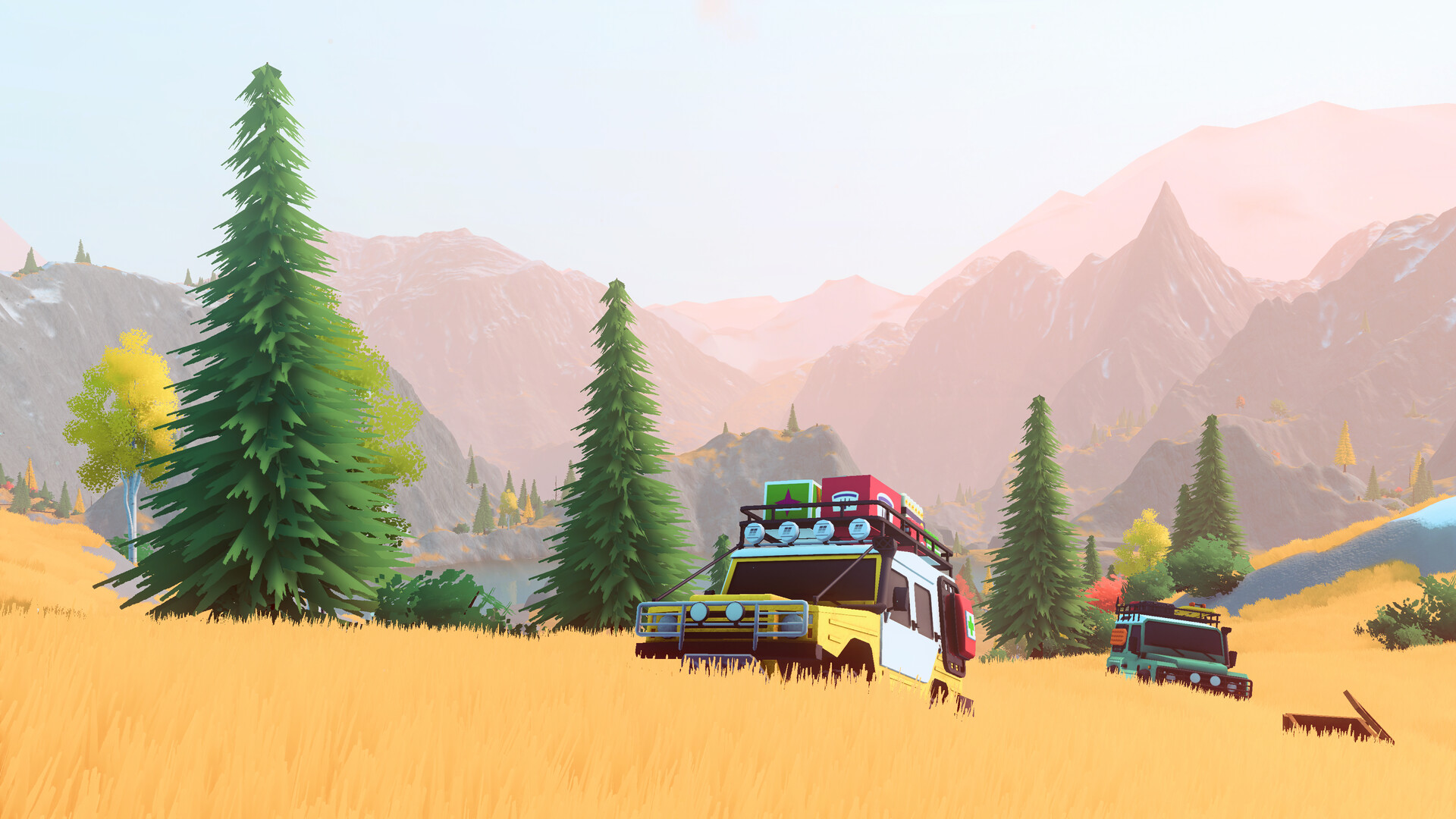 Two off-road vehicles in a golden mountain meadow