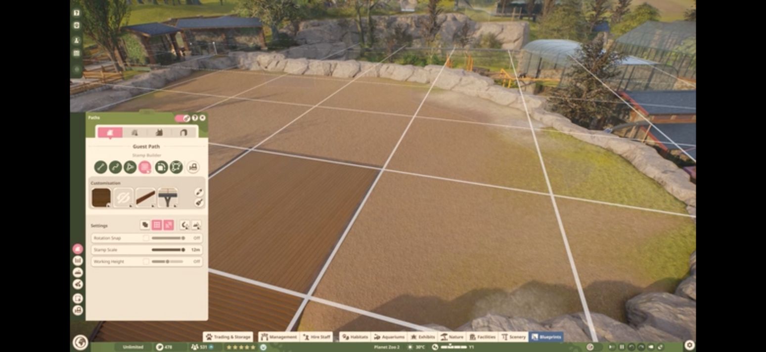 Planet Zoo 2 Stamp Builder panel beside a plaza construction grid