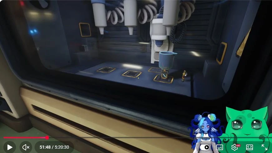 Through the chamber window, the cup sits beneath a nozzle while the miniature partner works below. Centre the receiving cup before requesting a dose.